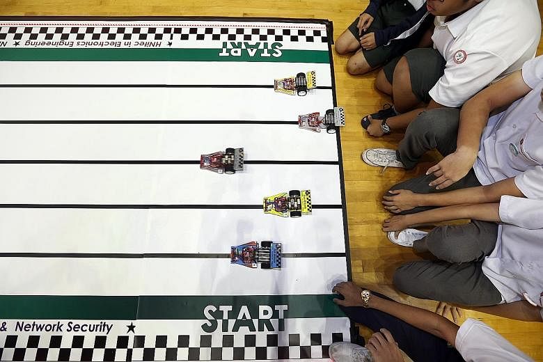 Students competing in a car race, one of the challenges in the competition.