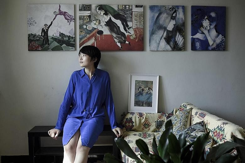 Ms Charlie Liu in her apartment in Beijing. She rents it out on Airbnb to help cover the repayments on her 1.4 million yuan mortgage.