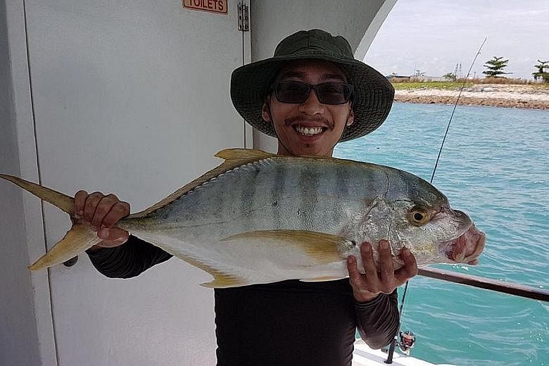 Mr Anthony Zhong (above) with a 7kg barramundi he caught in the waters around Pulau Ubin.