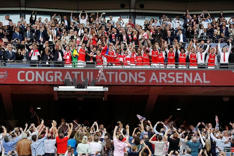 Arsenal lifting the trophy for the 13th time after an eventful game at Wembley packed with controversy. 