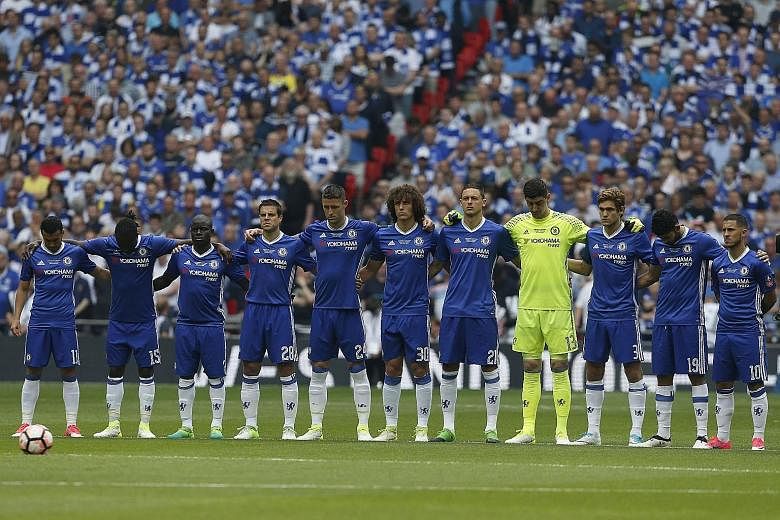 Chelsea’s players, led by Gary Cahill (centre), observe a minute’s silence in memory of the Manchester bombing victims. The Blues, however, initially forgot to wear black armbands. 