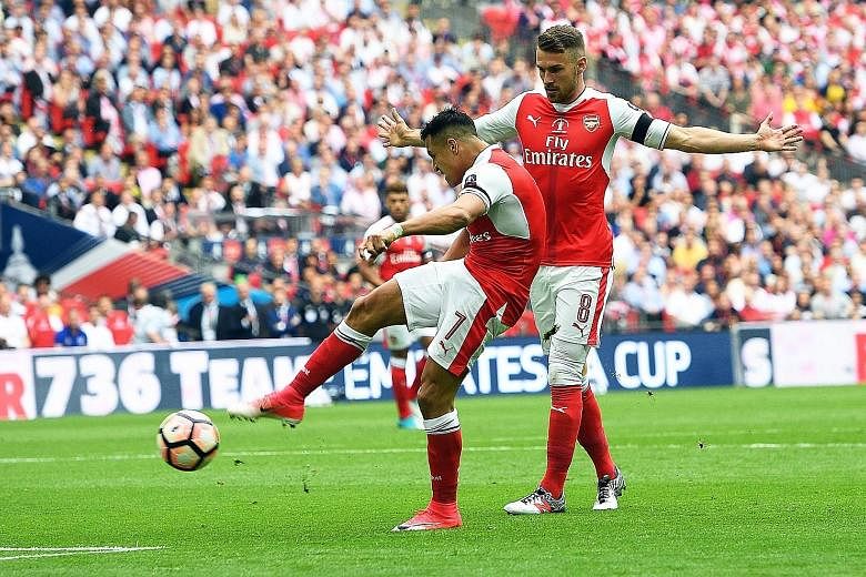 Alexis Sanchez puts Arsenal in front after having two calls go his way. The Chilean was not punished for a handball in the build-up while team-mate Aaron Ramsey was deemed to have not been interfering with play despite clearly straying offside. 