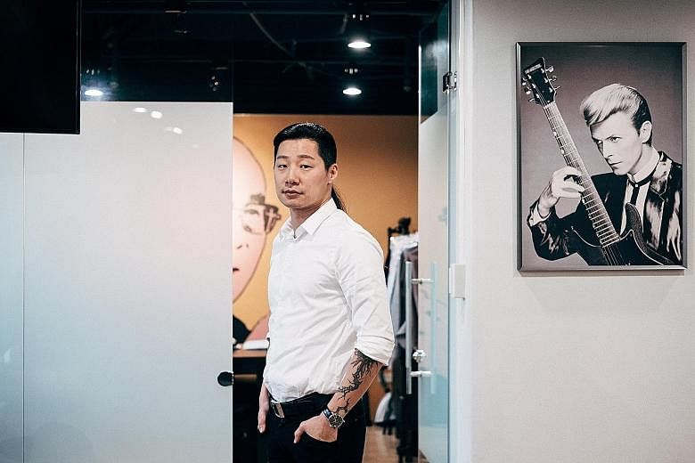 A poster of singer David Bowie hangs in the office of Freddy Lim (left), who has put his music career of more than two decades on hold to serve as a member in Taiwan's Legislative Yuan, or parliament.