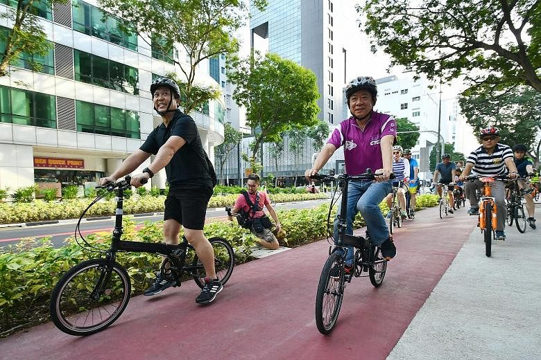 Coordinating Minister for Infrastructure and Minister for Transport Khaw Boon Wan using a dedicated cycling path at the launch of the revitalised Bencoolen Street yesterday.