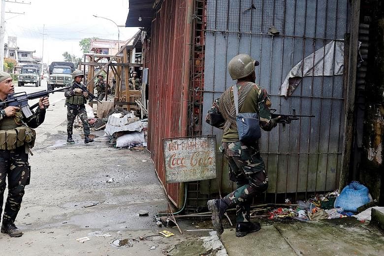 Left: Empty shells and bullets retrieved near the site where the bodies were found outside Marawi City. The grisly discovery confirms speculation that Maute rebels had killed civilians during a takeover of Marawi - a move the military believes is aim