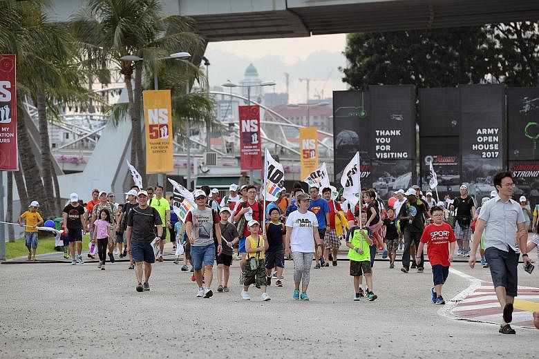 Participants of the Dads for Life Camp near the F1 Pit Building during the 3km Family Route March yesterday evening.