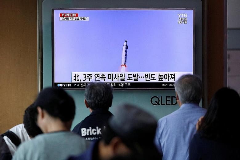 People watching a news report at a railway station in Seoul about North Korea firing what appeared to be a short-range ballistic missile yesterday.