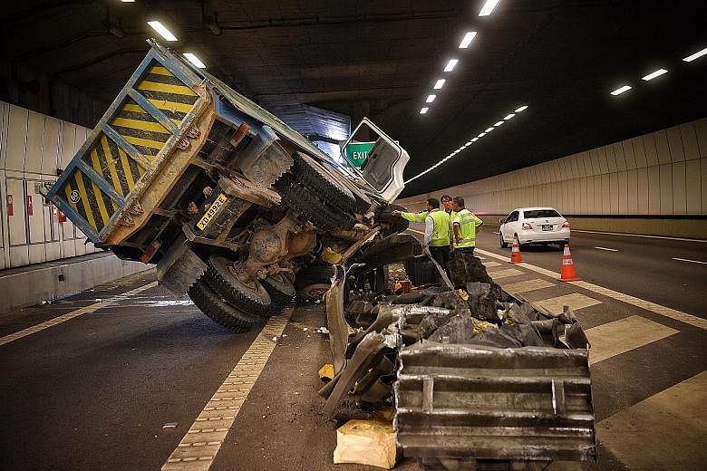 It took two cranes over an hour to move the tipper truck aside to clear the way to the Nicoll Highway exit. The truck had hit a tunnel wall, causing the driver to lose control of the vehicle, which then hit a divider.