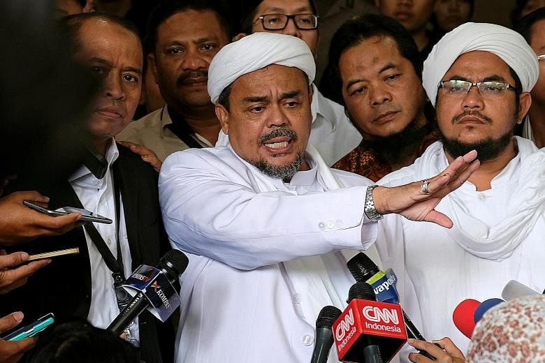 Habib Rizieq talking to reporters outside a court after the blasphemy trial of Jakarta's outgoing governor Basuki Tjahaja Purnama in the Indonesian capital in February.