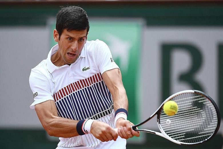 Defending champion Novak Djokovic hitting a backhand during his 6-3, 6-4, 6-2 win against Spain's Marcel Granollers in the first round at Roland Garros yesterday.