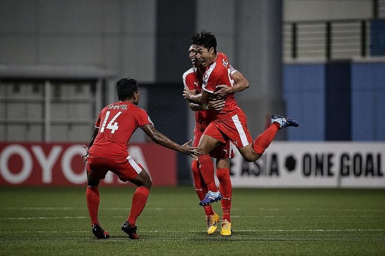 Home United midfielder Song Ui Young (right) celebrating with Afiq Yunos and Shamil Sharif after scoring the equaliser with a half-volley against Global FC in the second leg of their AFC Cup Asean zonal semi-final last night at Jalan Besar Stadium. T