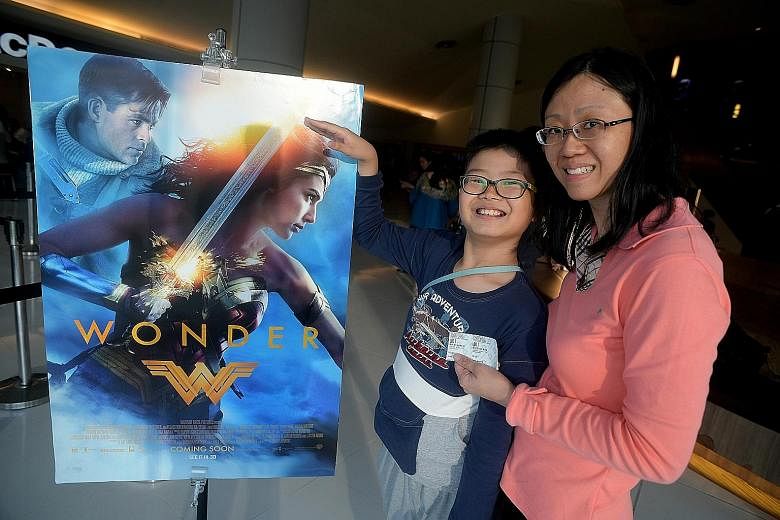 Nathaniel Teo and his mother, Mrs Cherilyn Teo, were among 320 Straits Times readers who won free tickets to watch Wonder Woman yesterday.
