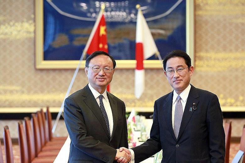 Chinese State Councillor Yang Jiechi (left) and Japanese Foreign Minister Fumio Kishida in Tokyo yesterday. Mr Yang said both countries need to build political trust and said China should be seen as a partner instead of a threat.