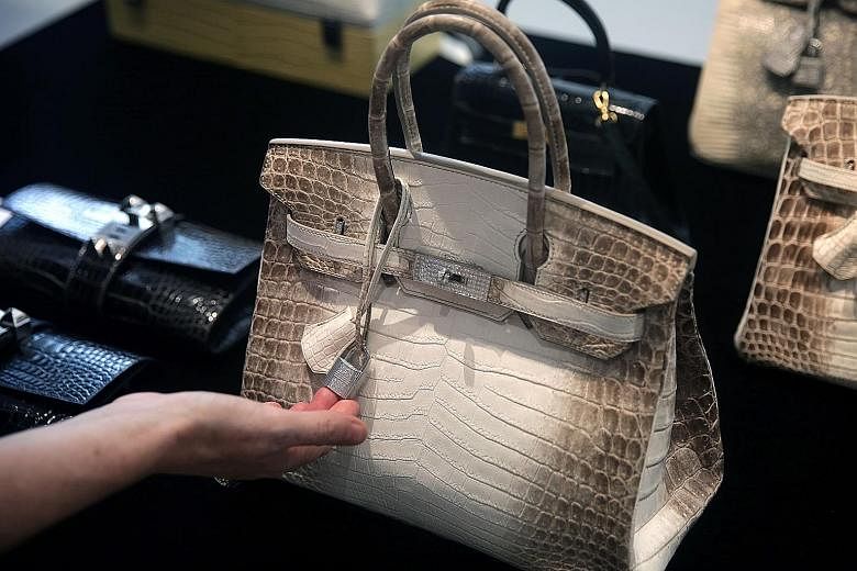 A Himalaya Niloticus Crocodile Diamond Birkin 30 on display at a preview at Christie's in Hong Kong last year. It is identical to the Hermes handbag that broke the record for the world's most expensive handbag sold at an auction yesterday. Only one o