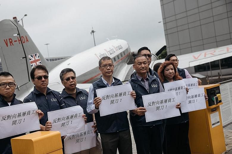 Cathay Pacific staff union representatives protesting against the airline's retrenchment exercise in Hong Kong last week. Asia's biggest international airline will eliminate 600 jobs as part of the biggest revamp in two decades, following its first l