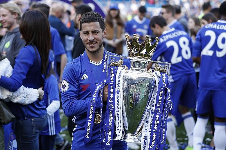 Chelsea's Eden Hazard with the English Premier League trophy at Stamford Bridge on May 21. He said that despite the club returning to the Champions League next season, it is the Blues' intention to keep the EPL title in their possession.