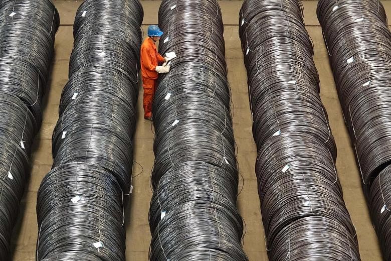A worker checking steel wires at a warehouse in Dalian, Liaoning province, China. Activity in China's steel industry rebounded sharply last month, contributing to a faster growth in the manufacturing sector.