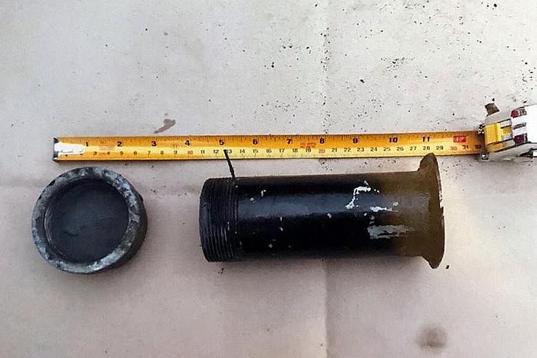 The cylindrical steel tube (left) the police found was packed with 220g of low-pressure explosives and placed in a green basket inside a black plastic bag packed with cut metal, screws and nails (right).