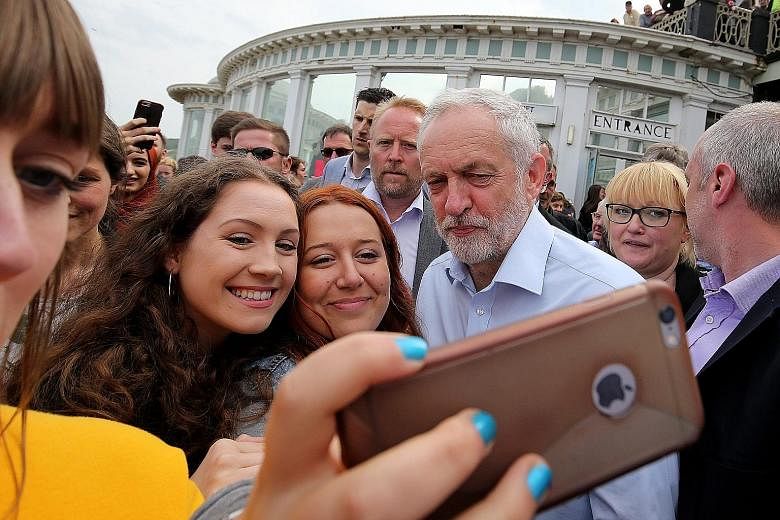 Labour Party leader Jeremy Corbyn (right) taking selfies with supporters during a rally in Scarborough on May 22.