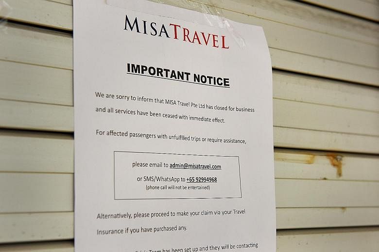 Misa Travel's office at Hong Lim Complex was shut yesterday. A notice put up on the shutters (far right) says the company is no longer in business.