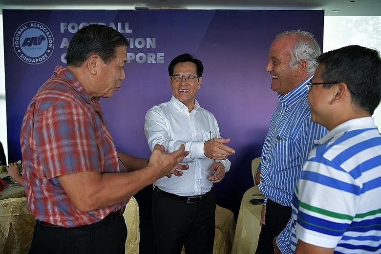 New FAS president Lim Kia Tong (white shirt) meeting staff for lunch at Jalan Besar Stadium on his first day of work on May 2. He had pledged that his team would work hard to heal Singapore football.