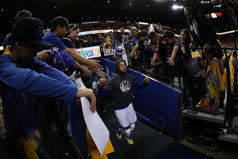 Stephen Curry of the Golden State Warriors running out of the tunnel at Oracle Arena, the scene of last year's late collapse against the Cleveland Cavaliers, during the conference semi-finals. The Warriors have reached the Finals with a perfect 12-0 