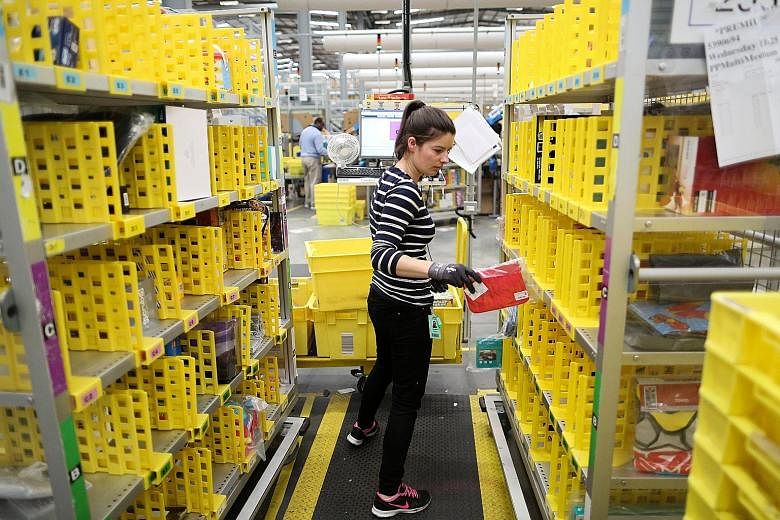An employee at an Amazon fulfilment centre in Britain. The world's largest online retailer faces several challenges as it seeks to enter Australia, including the vast distances between major population pockets, as well as high wages.