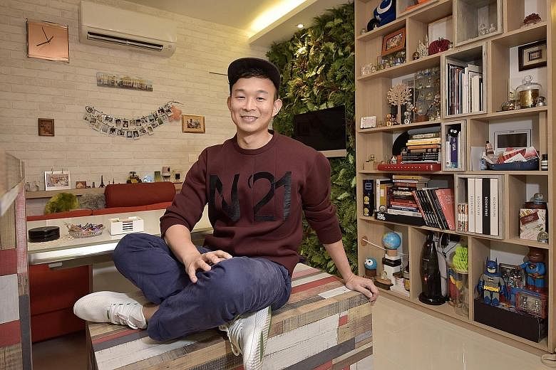 The loud colours of the kitchen cabinets complement the lime-green Smeg fridge. Fake lawn grass and potted plants decorate the balcony where the washing machine and dryer are. Mr Wee Ng on a custom-made bench that doubles as a storage compartment.