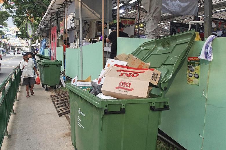 Rubbish bins at the back of food stalls along the street in Geylang Serai are sometimes left open. NEA made more than 148,500 inspections and took over 3,200 enforcement actions against food outlets last year, up from about 146,500 inspections and ab