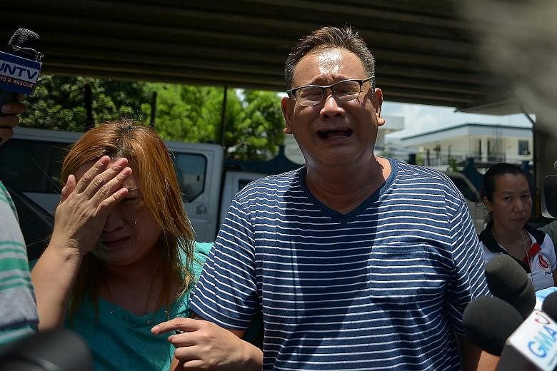 Relatives of one of the 36 victims who died are left distraught yesterday in the wake of the attack at the Resorts World Manila.