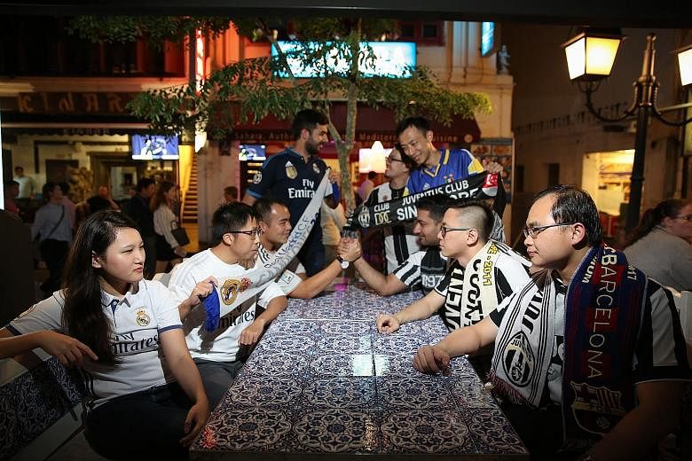 Real Madrid (left) and Juventus fans squaring off at the Sahara Bar & Restaurant, the venue where local Juve supporters will congregate to watch the Champions League final tonight.
