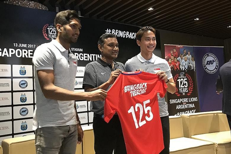 From left: Vice-captain Hariss Harun, national coach V. Sundramoorthy and captain Shahril Ishak commemorating the 125th anniversary of the founding of the Football Association of Singapore.