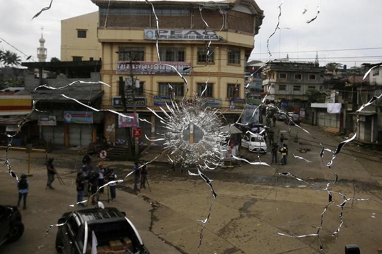A Marawi street seen through a window damaged during fighting between government soldiers and Maute militants last week. The proximity of the crisis there to other countries in the region has raised concerns that the terror scourge could spill over o