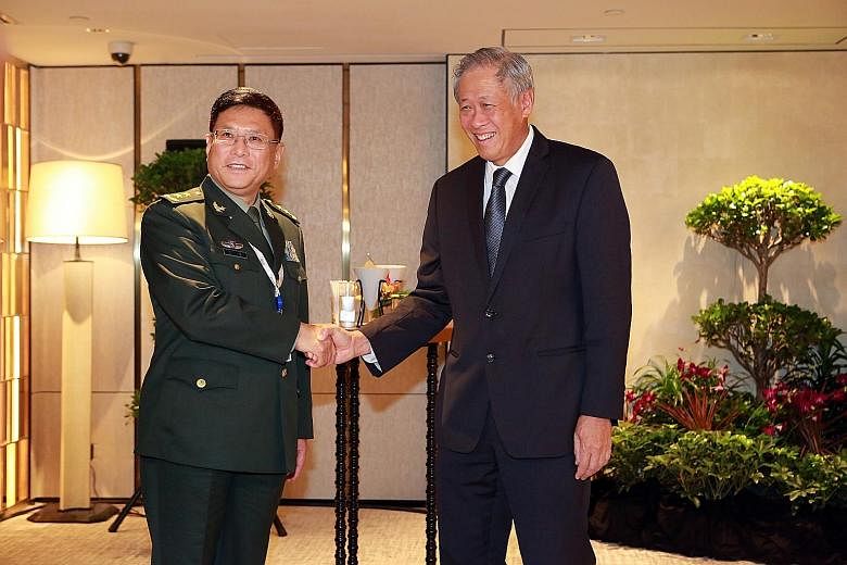 Defence Minister Ng Eng Hen greeting Lt-Gen He Lei, vice-president of the People's Liberation Army Academy of Military Sciences, at the Shangri-La Dialogue yesterday. Dr Ng and US Secretary of Defence James Mattis on their way to a breakfast meeting 