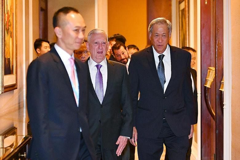 Defence Minister Ng Eng Hen greeting Lt-Gen He Lei, vice-president of the People's Liberation Army Academy of Military Sciences, at the Shangri-La Dialogue yesterday. Dr Ng and US Secretary of Defence James Mattis on their way to a breakfast meeting 