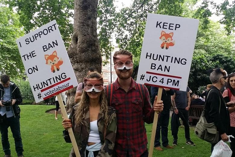 Beauty therapist Katrina Lawes and photographer Olly Dall protesting against fox hunting at a march in London last Monday. Prime Minister Theresa May has vowed to give Parliament a free vote to bring back the outlawed blood sport, which was banned in