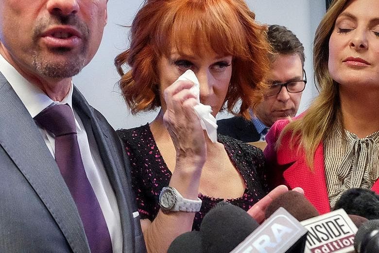 A tearful Kathy Griffin is flanked by her lawyers Dmitry Gorin (left) and Lisa Bloom at a news conference in Los Angeles on Friday. She is under investigation by the US Secret Service for a photo of her holding what looks like the decapitated head of