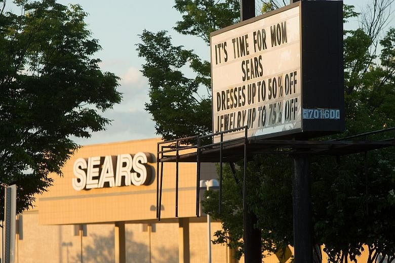 A sign heralds deep discounts at a Sears store in Alexandria, Virginia. Sears has seen six years of plunging sales and profit losses.