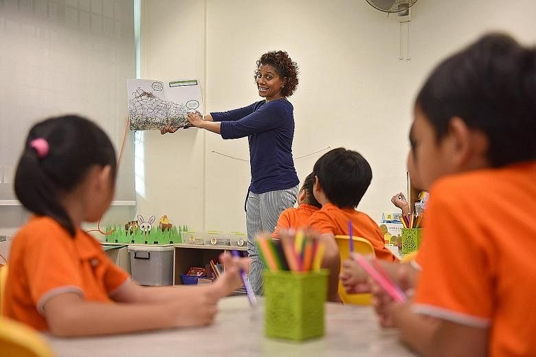 My First Skool teacher Shanthinayagi introducing her K2 class to the book A Crab, A Shell And A Little Help. The book about a hermit crab's quest for a new shell was written by Ms Han Rae Ann, Mr Bertrand Yan and Ms Natasha Hoong, and illustrated by 