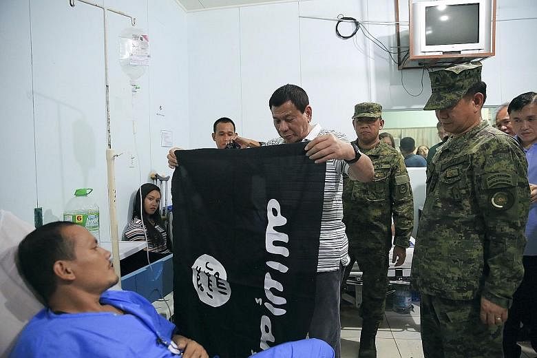 President Rodrigo Duterte visiting wounded soldiers at a military hospital in Cagayan de Oro in the southern Philippines. The ceasefire deal was initially reached following a meeting last week between Mr Duterte and the Moro Islamic Liberation Front.