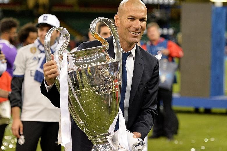 Real Madrid coach Zinedine Zidane holding the Champions League trophy aloft. Just 17 months into his tenure at the Santiago Bernabeu, the Frenchman has already eclipsed some of football's most hallowed names.