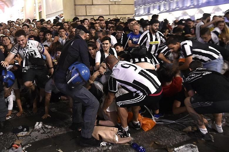 Juventus fans scrambling to get out of San Carlo Square in Turin, Italy, during the second half of last Saturday's Champions League final. Over 1,000 people were injured, seven seriously, following the mass panic, which was believed to have been spar