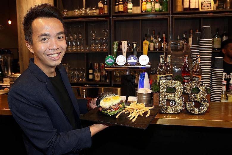 SMU Alumni Association general manager Edwin Lim is also the manager of B3, which stands for "burger, beer, bistro", and oversees its operations.