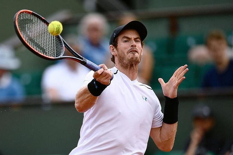 World No. 1 Andy Murray takes a forehand on the rise against Karen Khachanov, whom he beat 6-3, 6-4, 6-4 at the French Open yesterday. It took the Scot slightly more than two hours to overcome his powerful opponent.