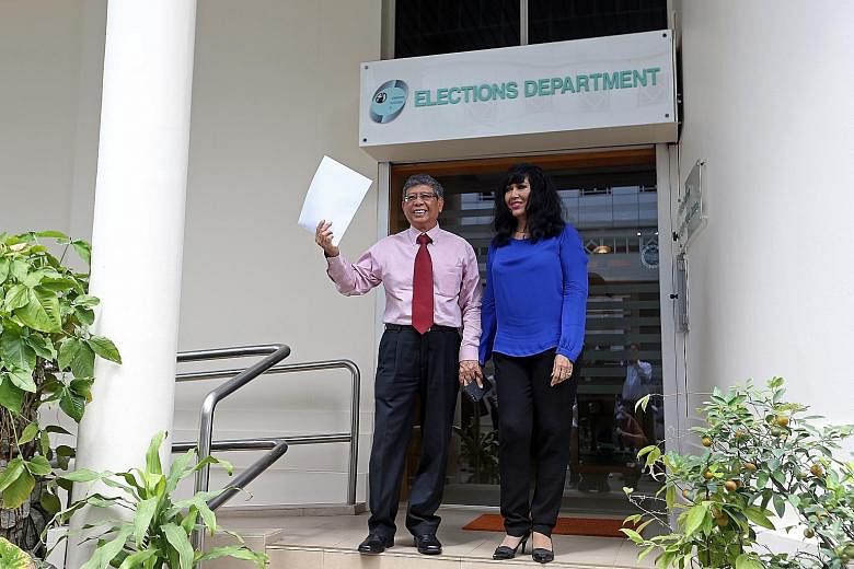 Second Chance Properties CEO Mohamed Salleh Marican with his wife Sapiyah Abu Bakar after collecting application forms for this September's presidential polls at the Elections Department yesterday.