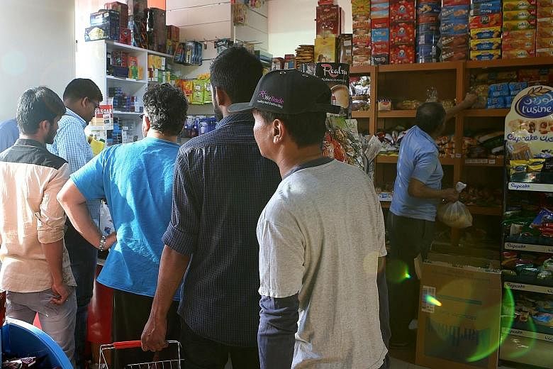People buying food at a shop in Doha on Monday, before panic-buying set in after five Arab nations cut ties with Qatar.