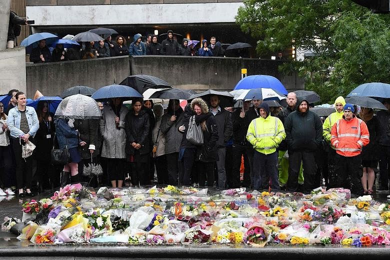 People observing a minute's silence on London Bridge yesterday to remember the seven people killed and dozens injured in the central London attack last Saturday.