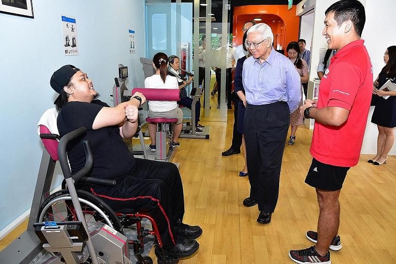 Former nurse Mohammad Sabree Salleh (far left) with President Tony Tan Keng Yam and ActiveSG senior fitness instructor Alan Chong at the Enabling Village yesterday. Dr Tan emphasised the need for a more inclusive Singapore.