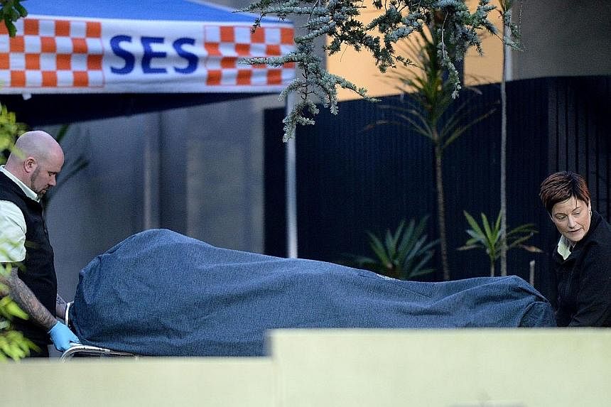 Officers removing a body from the scene of a deadly shoot-out in the Melbourne suburb of Brighton. Yacqub Khayre had allegedly murdered a Chinese-born Australian man working as a receptionist and took a female escort hostage at the serviced apartment