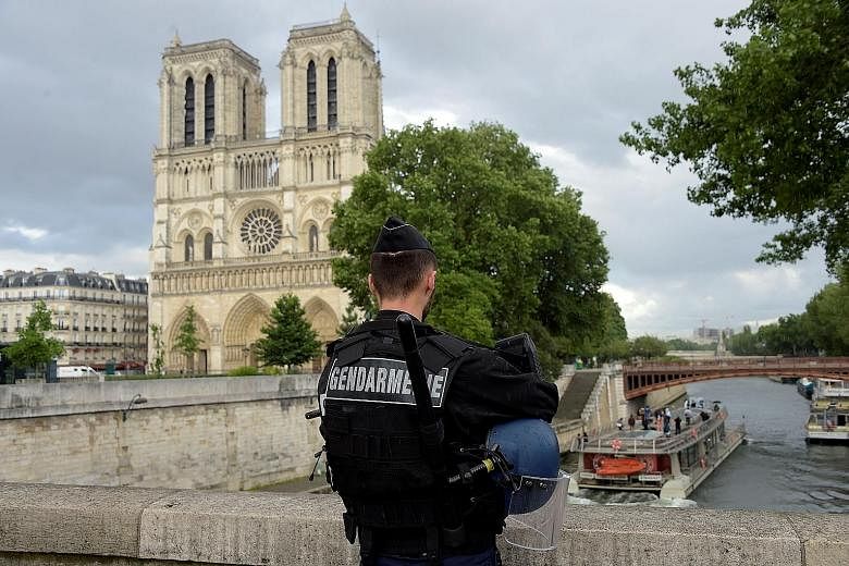 A gendarmeguards the attack site, Notre-Dame Cathedral, on Tuesday.
